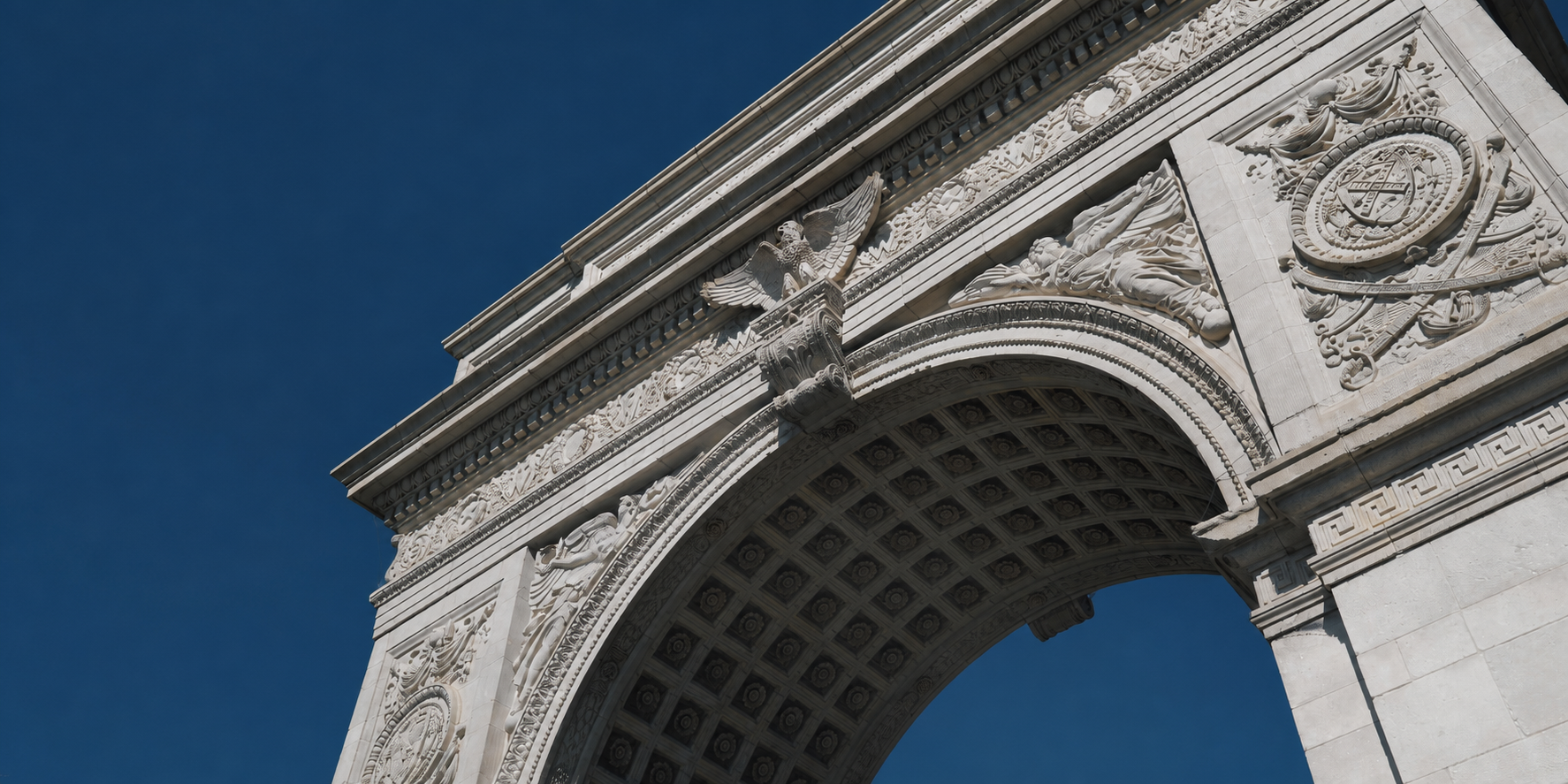The Washington Square Arch against a deep blue sky